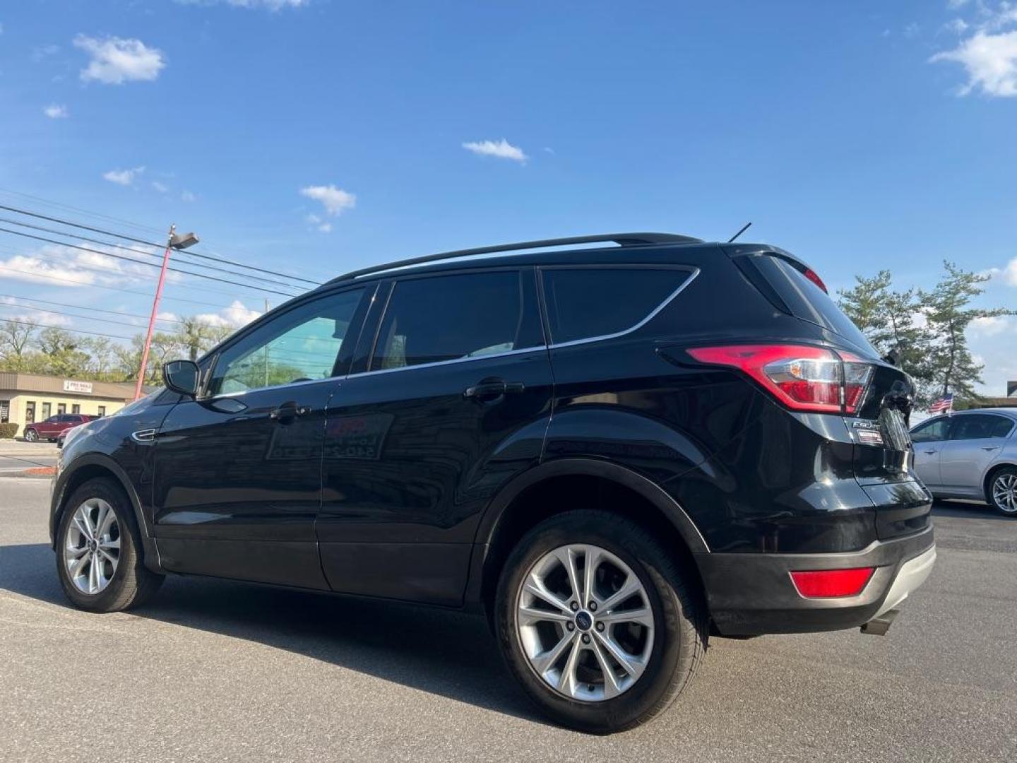 2018 BLACK FORD ESCAPE SE (1FMCU0GD1JU) with an 1.5L engine, Automatic transmission, located at 2514 Williamson Rd NE, Roanoke, VA, 24012, (540) 265-7770, 37.294636, -79.936249 - Photo#2